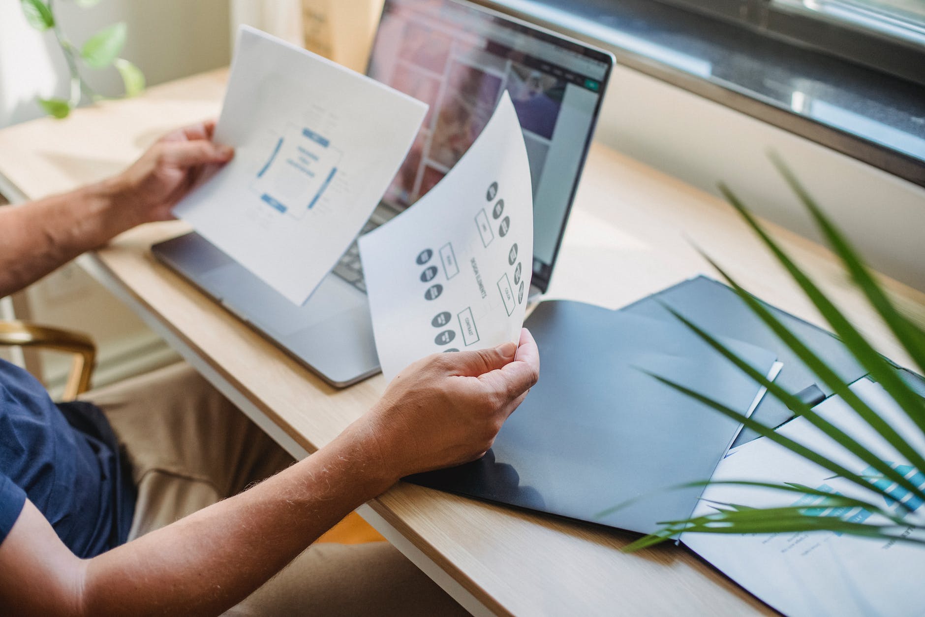 crop man with documents and laptop at table